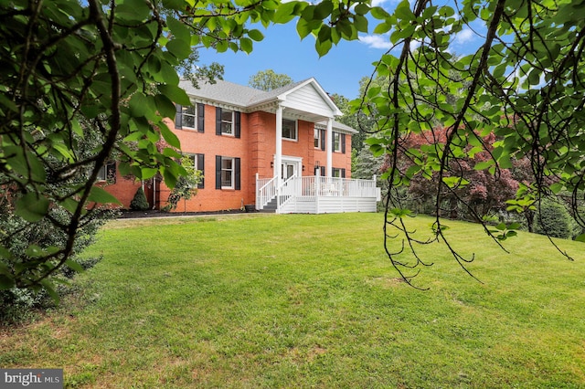 2725 Woodridge Ct, West Friendship, MD 21794 - view of front facade with brick siding, a front yard, and a wooden deck