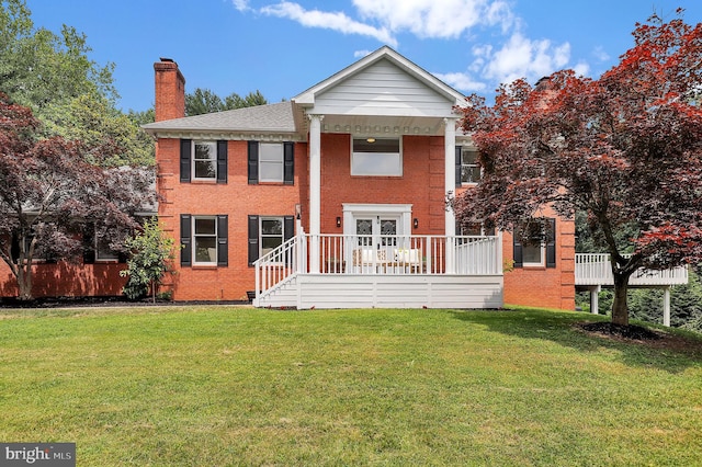 2725 Woodridge Ct, West Friendship, MD 21794 - back of house with a chimney, brick siding, a lawn, and a shingled roof