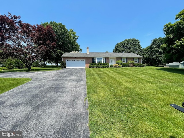 120 Locust Knoll Rd, Downingtown, PA 19335 - ranch-style home featuring asphalt driveway, an attached garage, a chimney, and a front yard