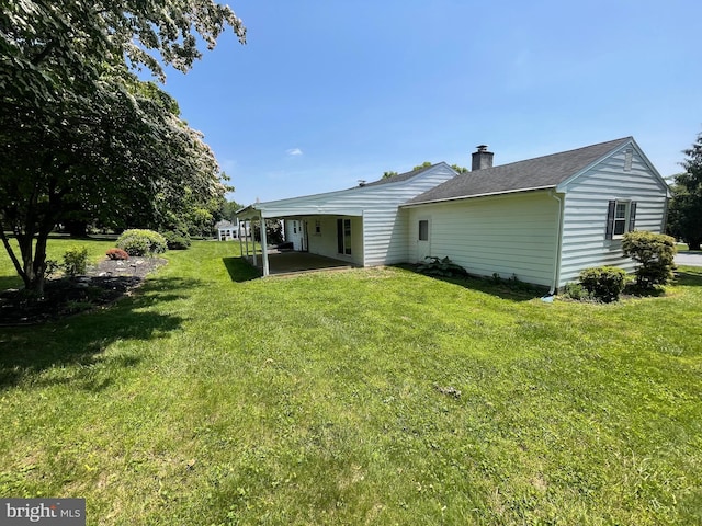 120 Locust Knoll Rd, Downingtown, PA 19335 - back of property featuring a chimney, a lawn, and a patio