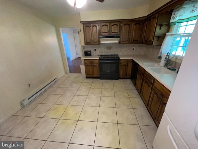 120 Locust Knoll Rd, Downingtown, PA 19335 - kitchen featuring black appliances, a baseboard heating unit, under cabinet range hood, light countertops, and backsplash