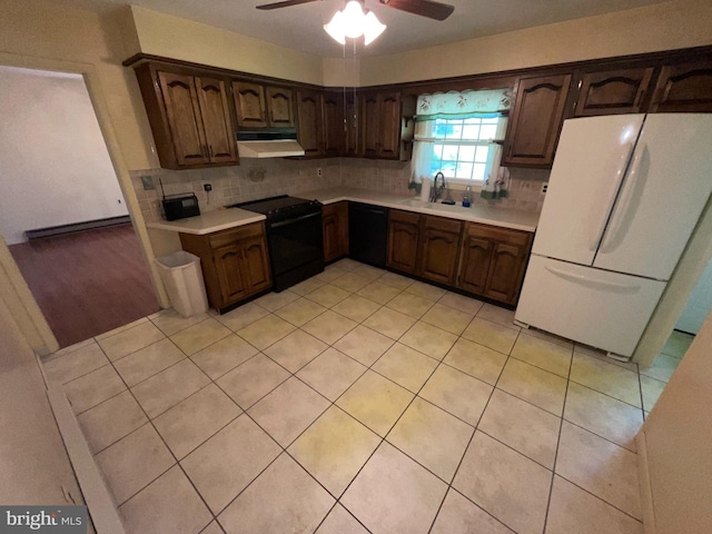 120 Locust Knoll Rd, Downingtown, PA 19335 - kitchen with black appliances, under cabinet range hood, a sink, and light countertops