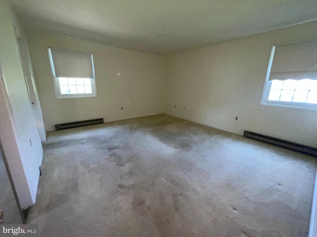 120 Locust Knoll Rd, Downingtown, PA 19335 - empty room featuring a baseboard radiator, healthy amount of natural light, and carpet