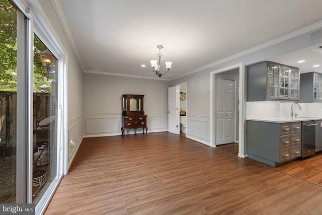 23 Penny Ln Unit 23, Baltimore, MD 21209 - unfurnished living room with a chandelier, crown molding, wood finished floors, wainscoting, and recessed lighting