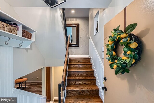 23 Penny Ln Unit 23, Baltimore, MD 21209 - stairs featuring wood finished floors and a wainscoted wall