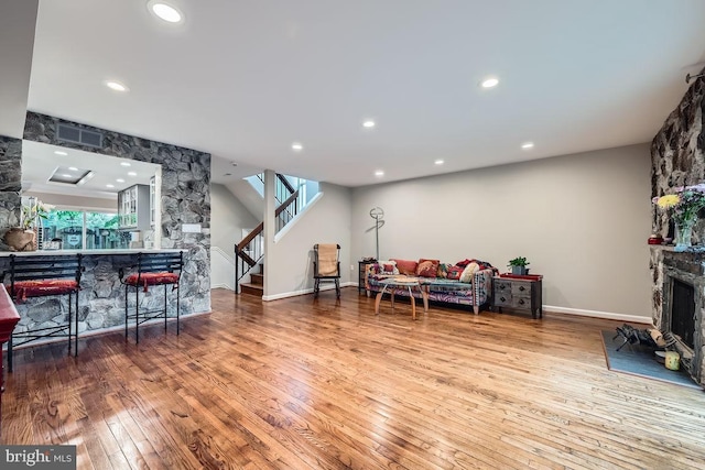 23 Penny Ln Unit 23, Baltimore, MD 21209 - living area with stairway, hardwood / wood-style floors, recessed lighting, and a stone fireplace