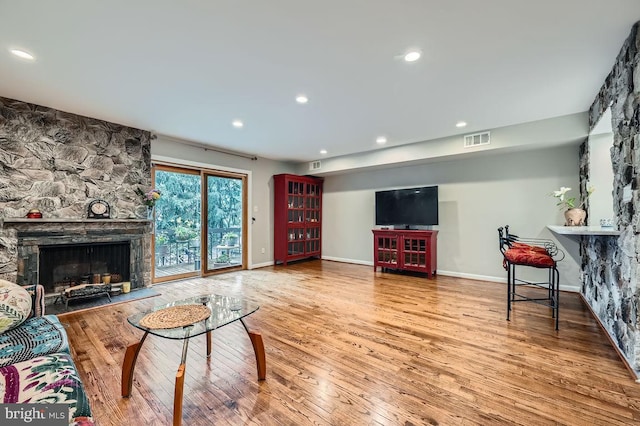 23 Penny Ln Unit 23, Baltimore, MD 21209 - living area with a stone fireplace, wood finished floors, and recessed lighting