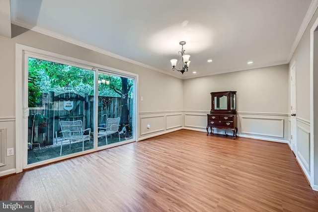 23 Penny Ln Unit 23, Baltimore, MD 21209 - unfurnished room with a chandelier, plenty of natural light, a decorative wall, wood finished floors, and ornamental molding