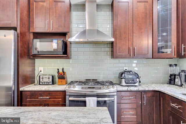 1128 S 24th St S, Philadelphia, PA 19146 - kitchen featuring wall chimney range hood, stainless steel appliances, tasteful backsplash, and glass insert cabinets