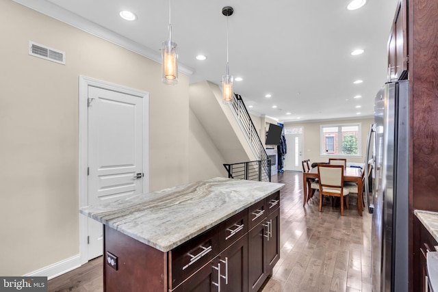 1128 S 24th St S, Philadelphia, PA 19146 - kitchen with freestanding refrigerator, wood finished floors, recessed lighting, ornamental molding, and light stone counters
