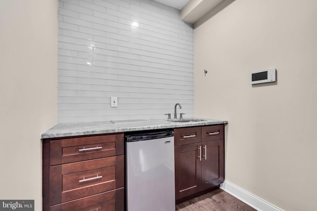 1128 S 24th St S, Philadelphia, PA 19146 - kitchen with refrigerator, dark wood-style flooring, and light stone counters