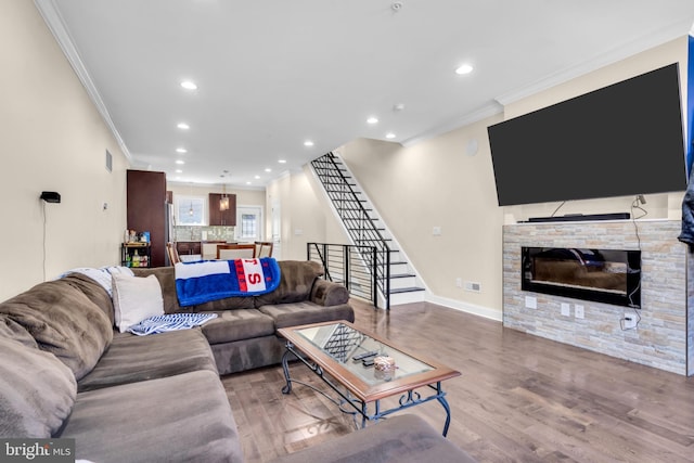 1128 S 24th St S, Philadelphia, PA 19146 - living room featuring crown molding, a glass covered fireplace, stairs, wood finished floors, and recessed lighting