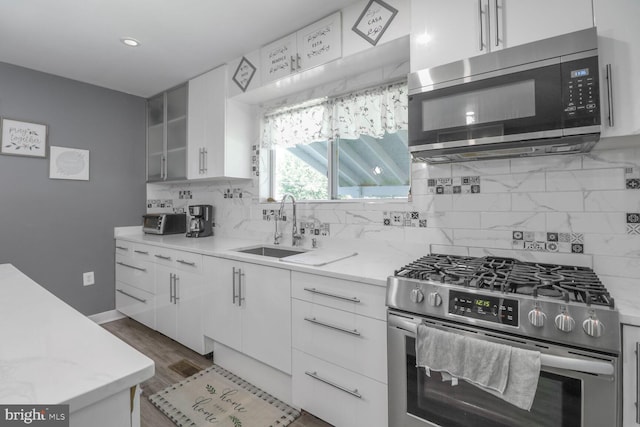104 Ferndale Rd, Glen Burnie, MD 21061 - kitchen with appliances with stainless steel finishes, decorative backsplash, white cabinetry, light stone countertops, and recessed lighting