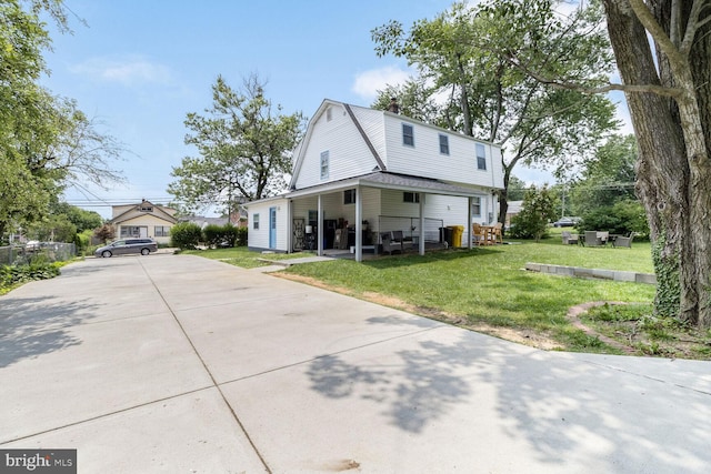 104 Ferndale Rd, Glen Burnie, MD 21061 - dutch colonial with a gambrel roof, concrete driveway, a front yard, and a chimney