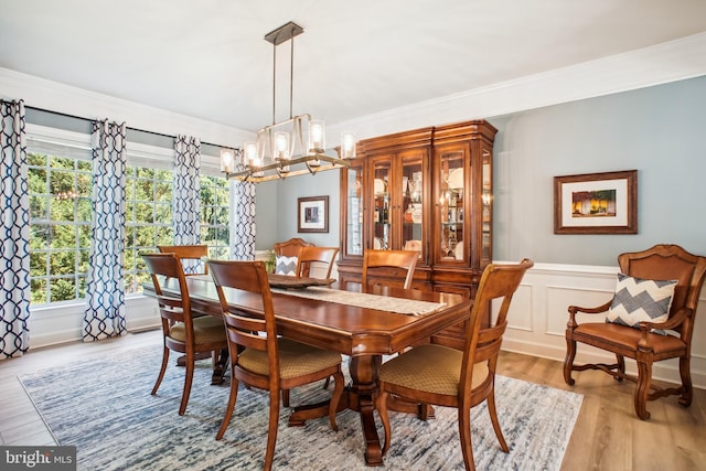 18510 Barton Creek Pl, Leesburg, VA 20176 - dining room with a chandelier, wood finished floors, plenty of natural light, wainscoting, and ornamental molding
