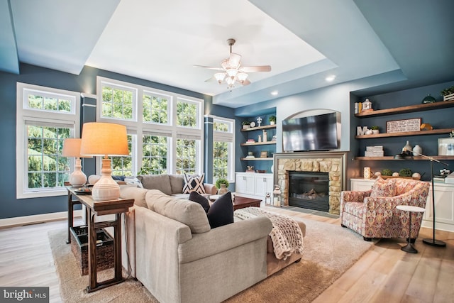 18510 Barton Creek Pl, Leesburg, VA 20176 - living area with ceiling fan, wood finished floors, a fireplace, built in features, and recessed lighting