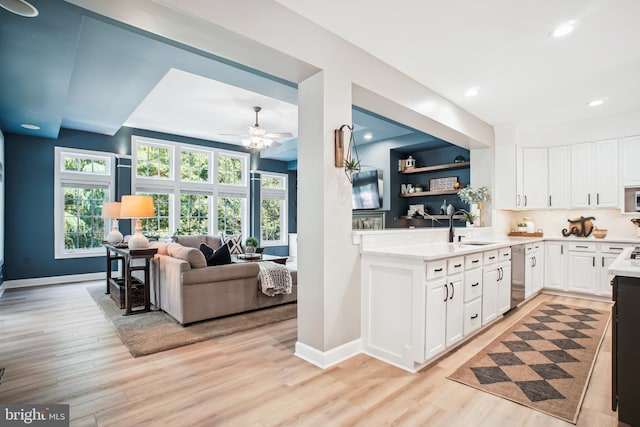 18510 Barton Creek Pl, Leesburg, VA 20176 - kitchen featuring stainless steel dishwasher, light wood finished floors, light countertops, ceiling fan, and white cabinetry