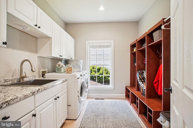 18510 Barton Creek Pl, Leesburg, VA 20176 - washroom featuring cabinet space, separate washer and dryer, light tile patterned floors, and recessed lighting
