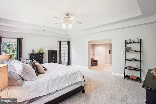 18510 Barton Creek Pl, Leesburg, VA 20176 - carpeted bedroom with a tray ceiling and ceiling fan