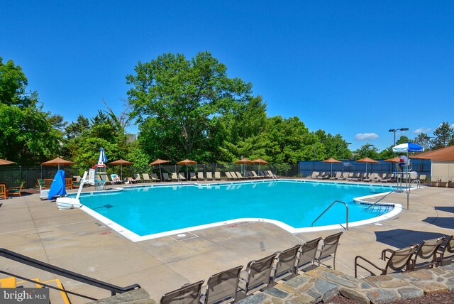 18510 Barton Creek Pl, Leesburg, VA 20176 - community pool with a patio area