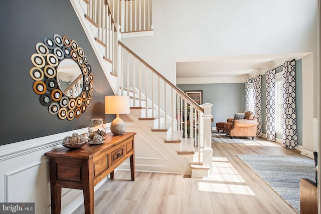 18510 Barton Creek Pl, Leesburg, VA 20176 - stairway featuring crown molding, wood finished floors, and a wainscoted wall