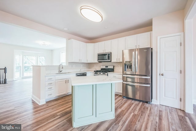 5514 Aeriel Pl, Frederick, MD 21703 - kitchen with appliances with stainless steel finishes, light wood-style floors, white cabinets, and backsplash