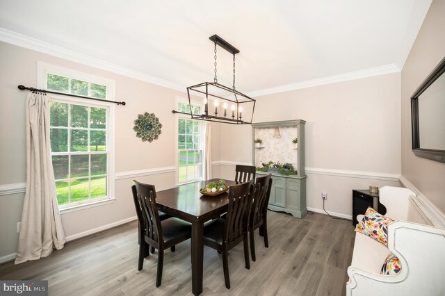 12424 Silent Wolf Dr, Manassas, VA 20112 - dining space with light wood finished floors, ornamental molding, and a chandelier