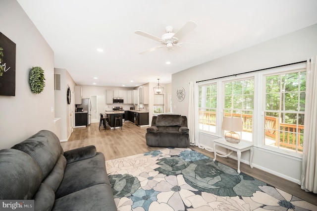 12424 Silent Wolf Dr, Manassas, VA 20112 - living room featuring light wood-style floors, ceiling fan, and recessed lighting