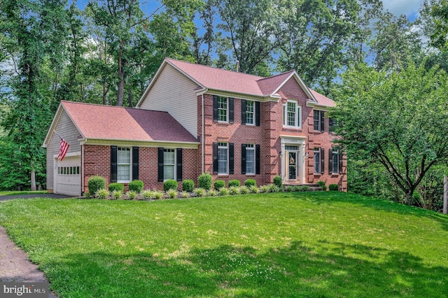 12424 Silent Wolf Dr, Manassas, VA 20112 - view of front of house with brick siding, asphalt driveway, a front lawn, and a garage