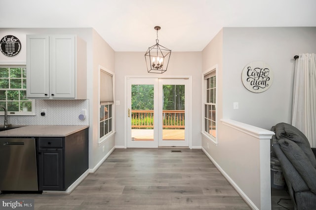 12424 Silent Wolf Dr, Manassas, VA 20112 - kitchen with dishwasher, a chandelier, light wood-style floors, and plenty of natural light