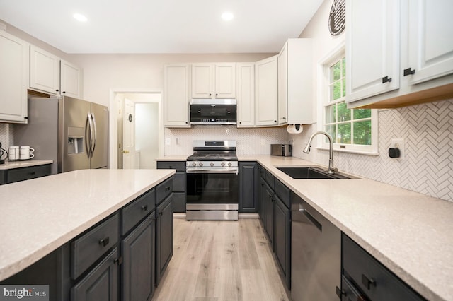 12424 Silent Wolf Dr, Manassas, VA 20112 - kitchen with appliances with stainless steel finishes, white cabinetry, tasteful backsplash, light countertops, and recessed lighting