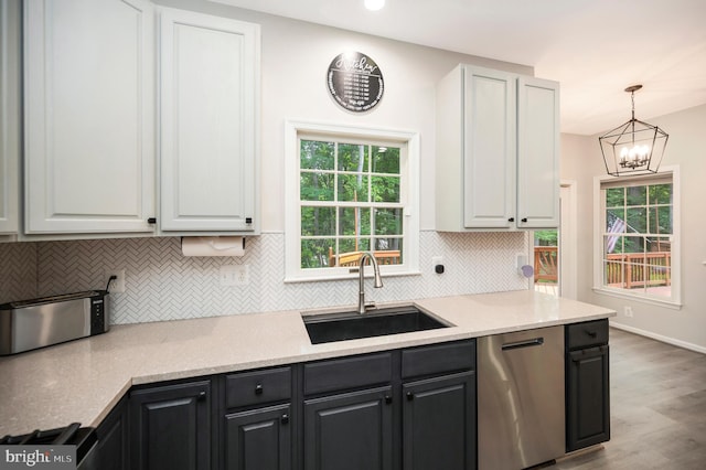 12424 Silent Wolf Dr, Manassas, VA 20112 - kitchen featuring stainless steel dishwasher, wood finished floors, tasteful backsplash, and healthy amount of natural light