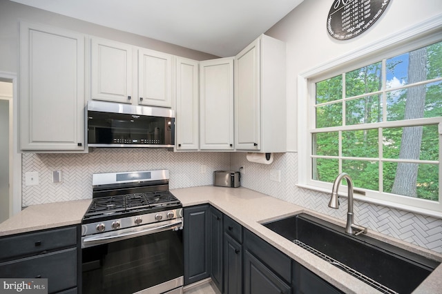 12424 Silent Wolf Dr, Manassas, VA 20112 - kitchen with appliances with stainless steel finishes, white cabinetry, and tasteful backsplash