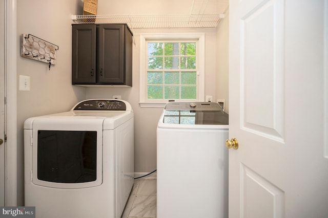 12424 Silent Wolf Dr, Manassas, VA 20112 - washroom with cabinet space, washer and dryer, and light marble finish flooring