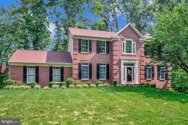 12424 Silent Wolf Dr, Manassas, VA 20112 - colonial-style house with a front yard and brick siding
