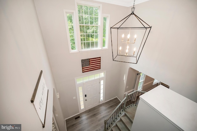 12424 Silent Wolf Dr, Manassas, VA 20112 - foyer with a chandelier, wood finished floors, a towering ceiling, and stairs