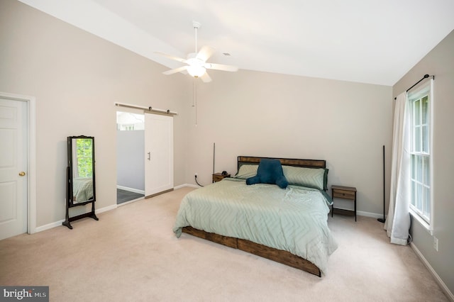 12424 Silent Wolf Dr, Manassas, VA 20112 - bedroom featuring a barn door, light carpet, high vaulted ceiling, and ceiling fan