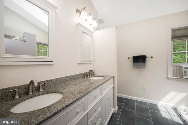 12424 Silent Wolf Dr, Manassas, VA 20112 - full bathroom with double vanity, tile patterned flooring, and vaulted ceiling