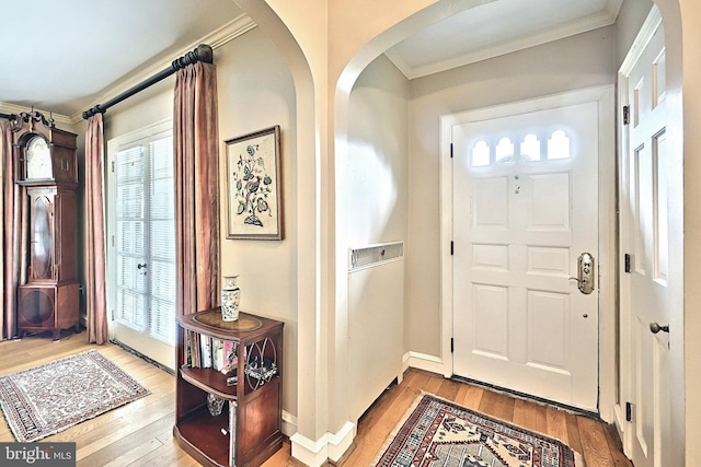 3172 N George St, Emigsville, PA 17318 - foyer entrance featuring wood-type flooring, arched walkways, ornamental molding, and plenty of natural light