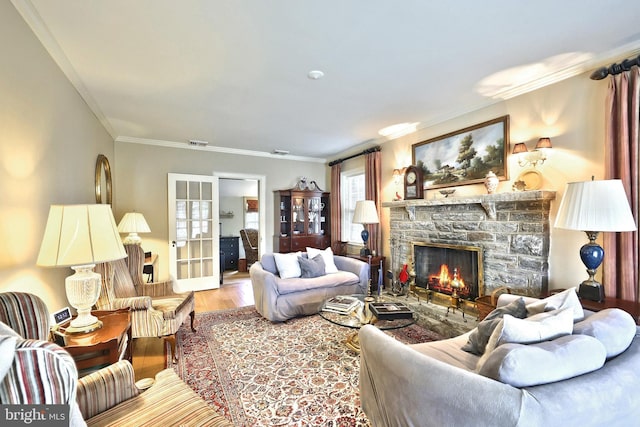 3172 N George St, Emigsville, PA 17318 - living room featuring a stone fireplace, wood finished floors, and crown molding