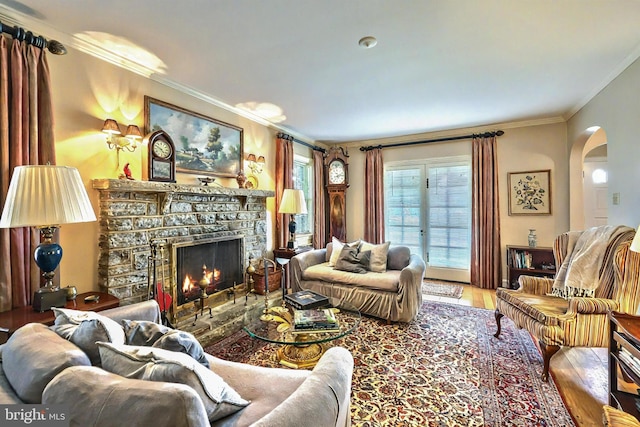 3172 N George St, Emigsville, PA 17318 - living room featuring arched walkways, ornamental molding, a fireplace, and wood finished floors
