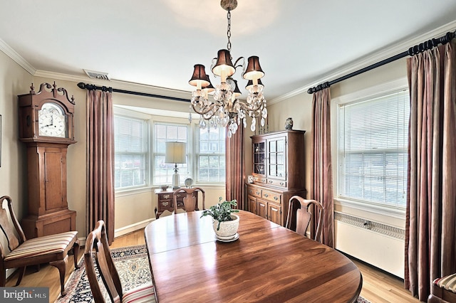 3172 N George St, Emigsville, PA 17318 - dining area featuring a chandelier, crown molding, and light wood-style flooring
