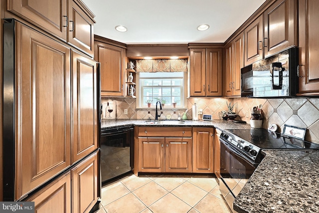 3172 N George St, Emigsville, PA 17318 - kitchen with black appliances, a sink, light tile patterned floors, dark stone countertops, and decorative backsplash