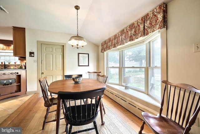 3172 N George St, Emigsville, PA 17318 - dining area featuring light wood-style floors, lofted ceiling, and a baseboard heating unit