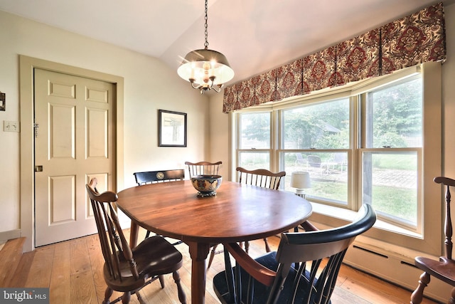 3172 N George St, Emigsville, PA 17318 - dining area featuring healthy amount of natural light, vaulted ceiling, a chandelier, and light wood finished floors