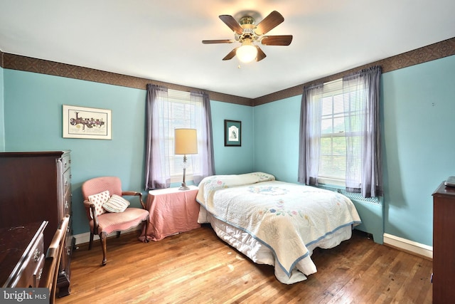 3172 N George St, Emigsville, PA 17318 - bedroom featuring hardwood / wood-style flooring, multiple windows, baseboards, and a ceiling fan