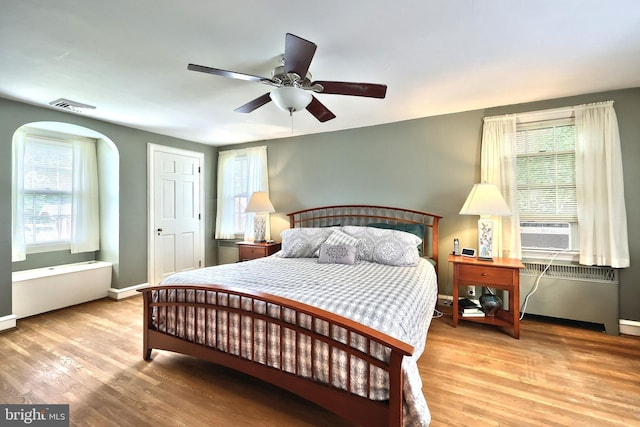 3172 N George St, Emigsville, PA 17318 - bedroom featuring radiator, multiple windows, and light wood-style flooring