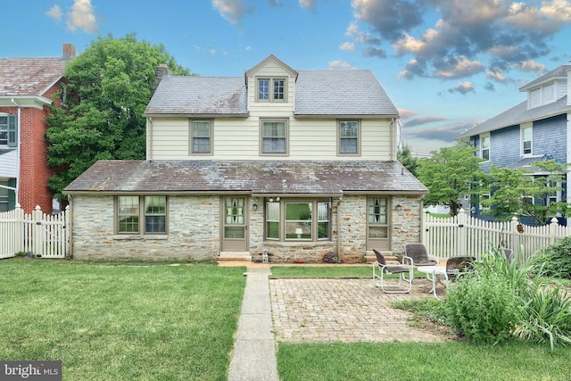3172 N George St, Emigsville, PA 17318 - view of front of house featuring a high end roof, stone siding, a patio, and a chimney