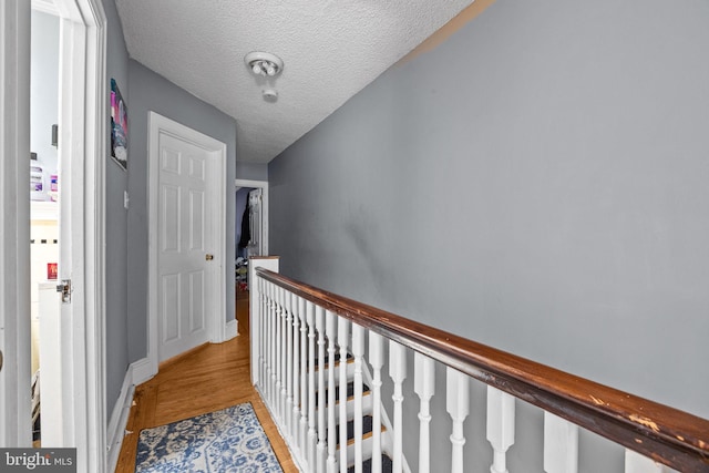 3537 Chippendale Ave, Philadelphia, PA 19136 - hall featuring an upstairs landing, a textured ceiling, and light wood-type flooring