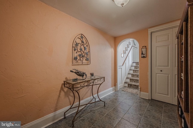 3305 Keswick Way Unit 3305D, West Chester, PA 19382 - entrance foyer featuring arched walkways, stairway, and dark tile patterned floors